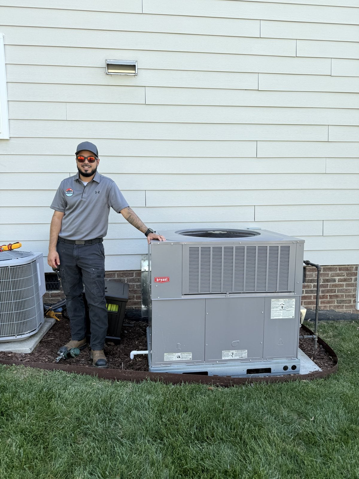 Jon Varela, co-owner of Skyline Comfort Services, beside a completed packaged-unit installation