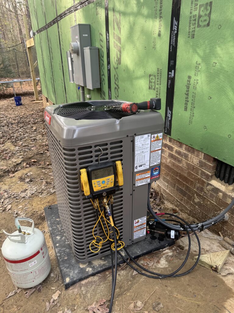 New outdoor heat pump unit being charged at start-up on a Raleigh, NC home.